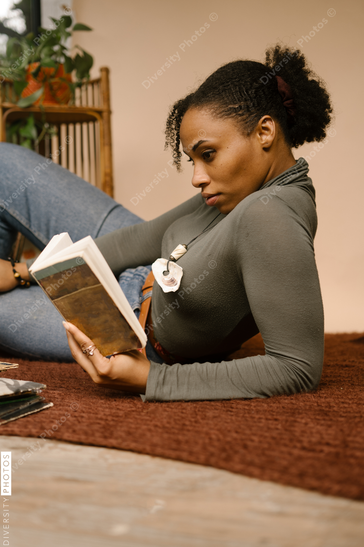 Portrait of woman reading book at home