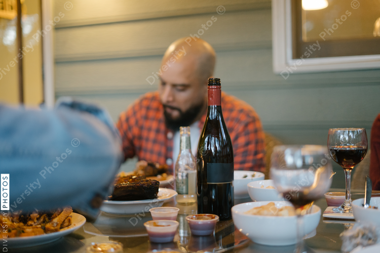 Friends eating BBQ together safely in vacation pod
