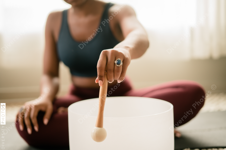 Woman using stress relieving singing bowl