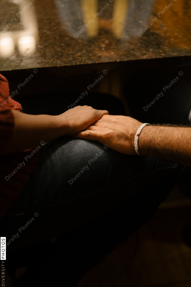 Black husband and wife holding hands tenderly