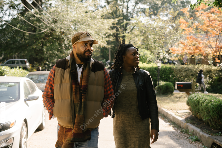 African American couple walking in neighborhood