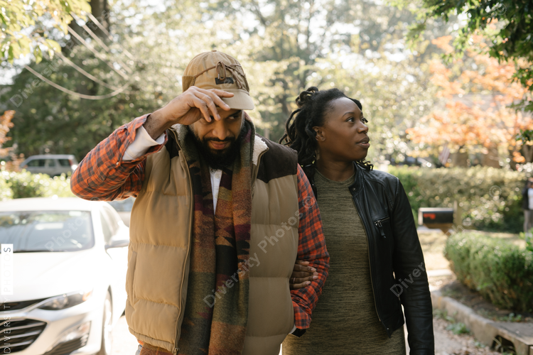 African American couple walking in neighborhood