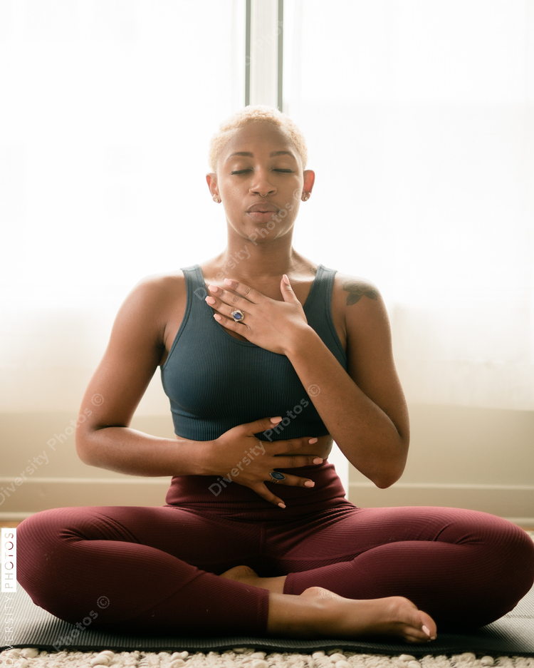 Black woman breathing and doing meditation at home