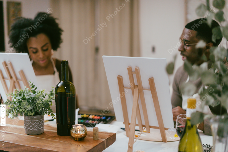 Black couple having at home date night, painting romantic DIY