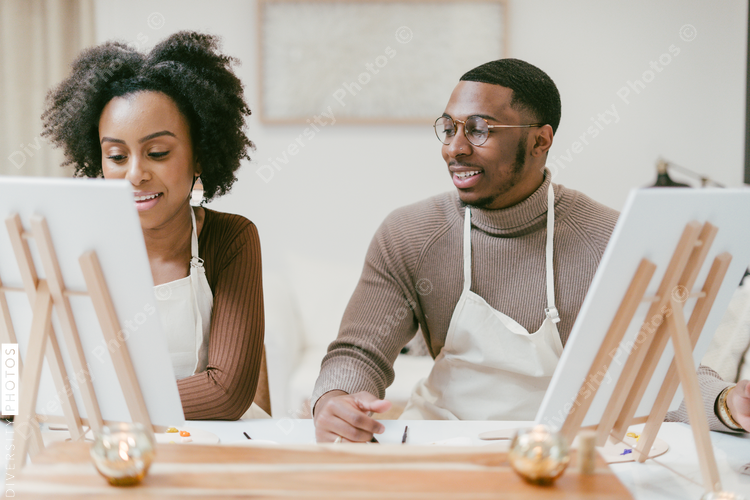 African American couple enjoys at home painting and craft date night, DIY