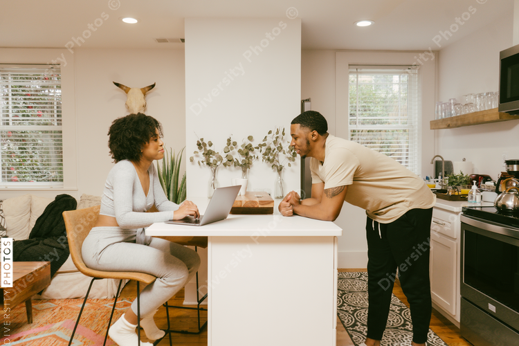 Cozy and comfy Black couple having conversation in kitchen