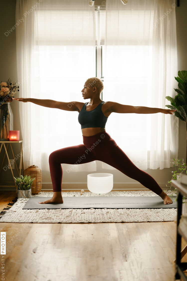 Young woman practices yoga at home