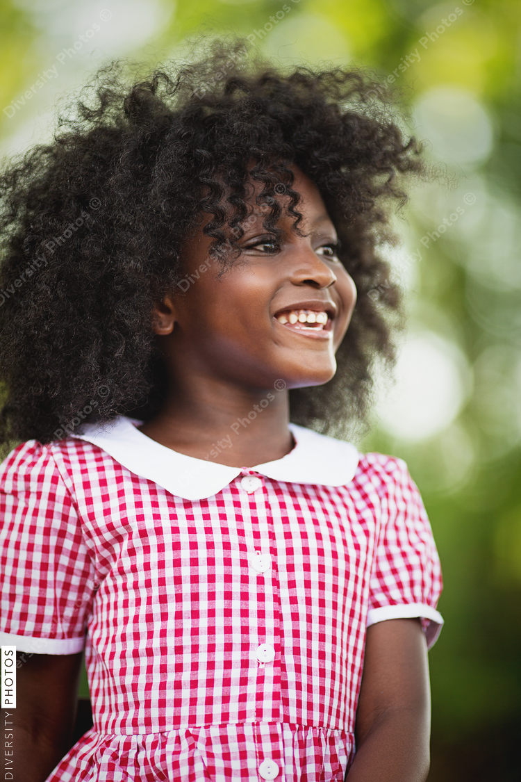Portrait of smiling girl in red and white gingham dress