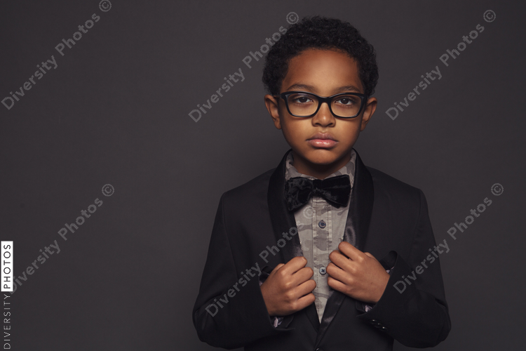 Portrait of boy posing against purple background
