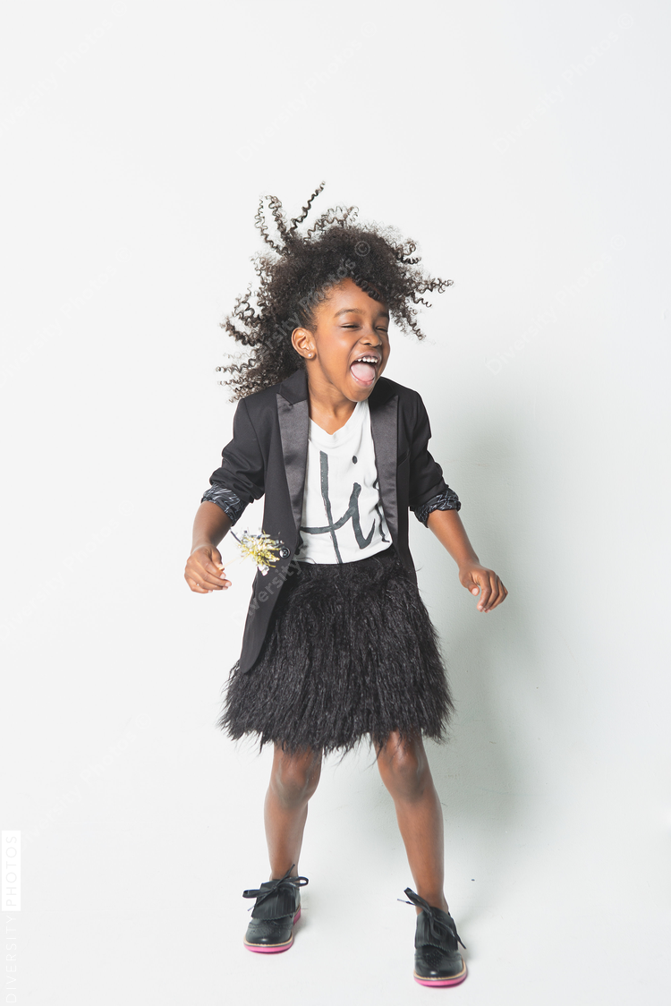 Playful girl standing against white background