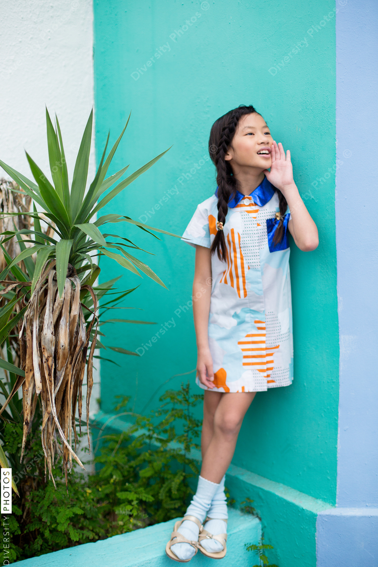 Girl shouting while leaning on wall