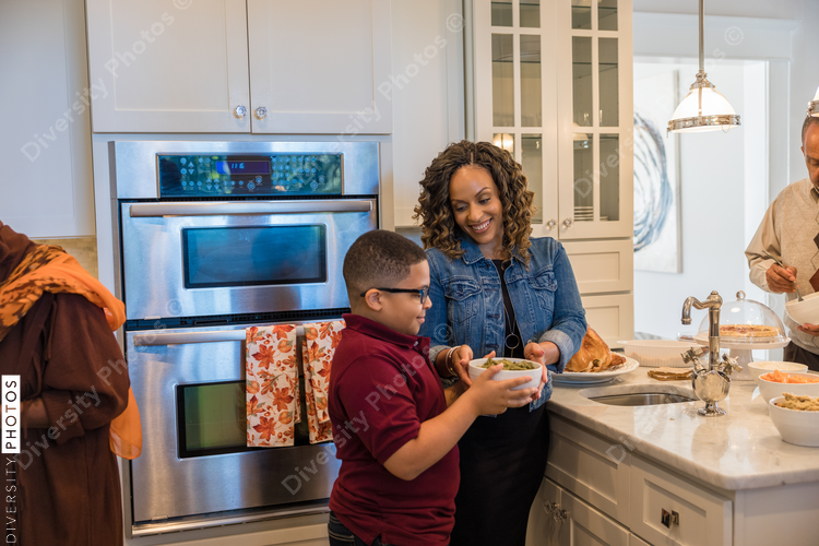Family prepares Thanksgiving food in kitchen