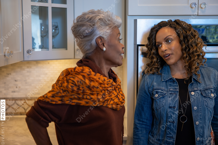 Black mother and daughter cooking in the kitchen