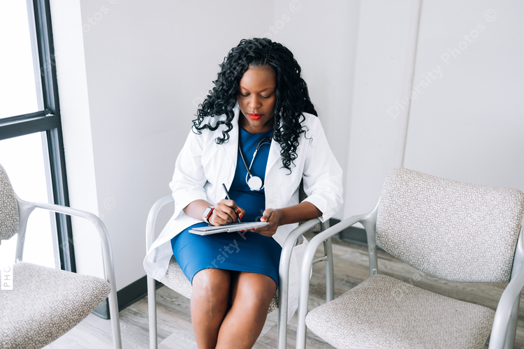 Black doctor reviews patient information prior to consultation