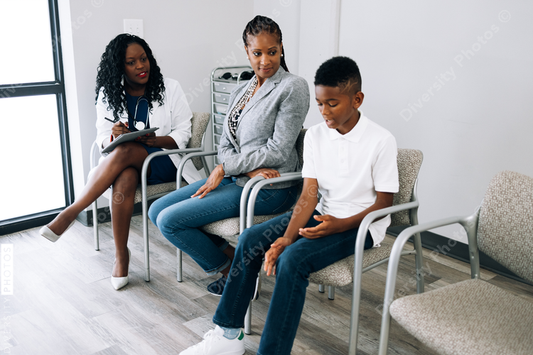 Black doctor consulting mother and son patients