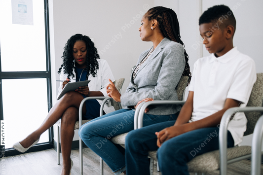 Black doctor consulting mother and son patients