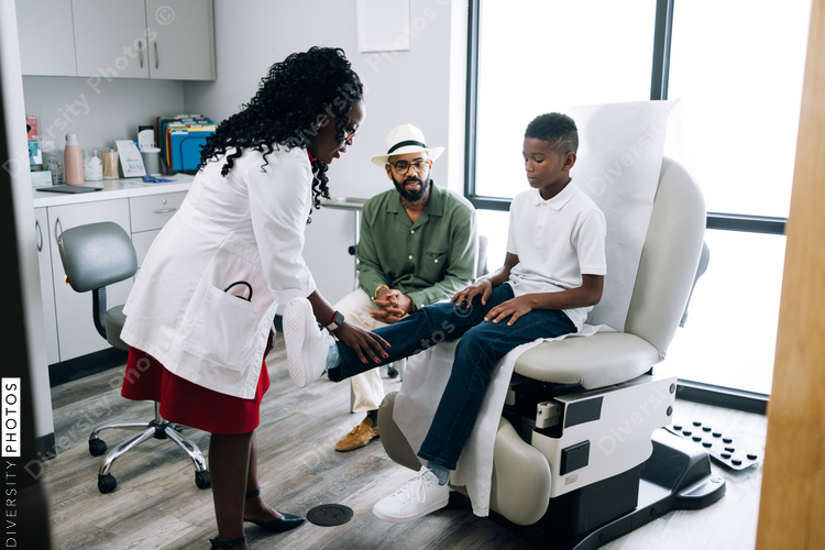 Black pediatrician does strength examination doctor patient consultation