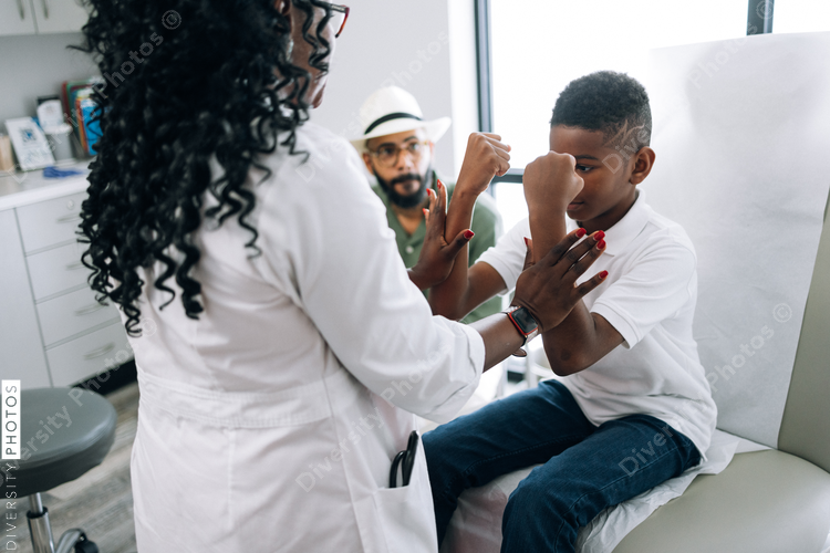 Black pediatrician does strength examination doctor patient consultation