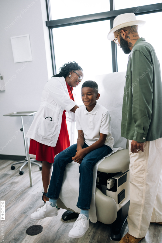 African American doctor consults dad and son