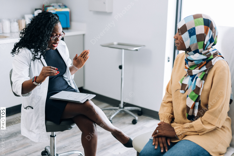 Doctor consulting Muslim patient wearing hijab