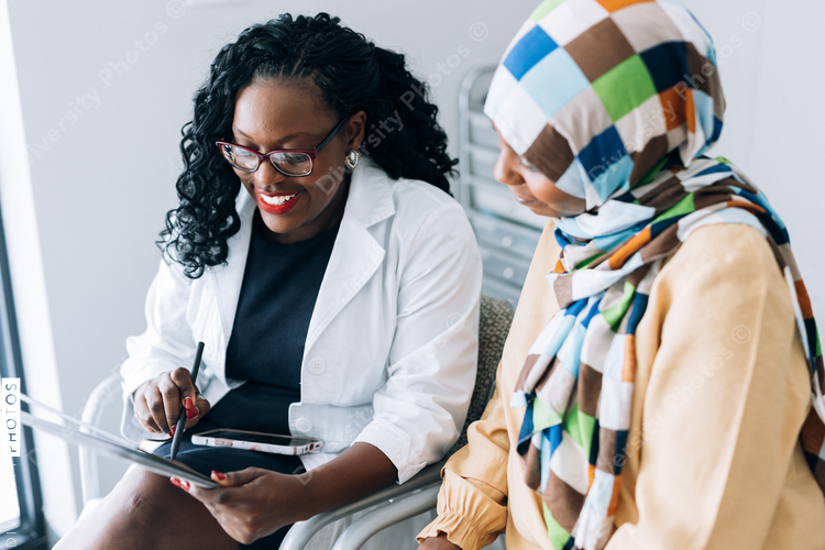 Doctor consulting Muslim patient wearing hijab