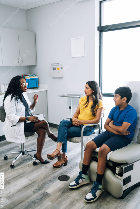 Black prediatric doctor consulting Indian patients