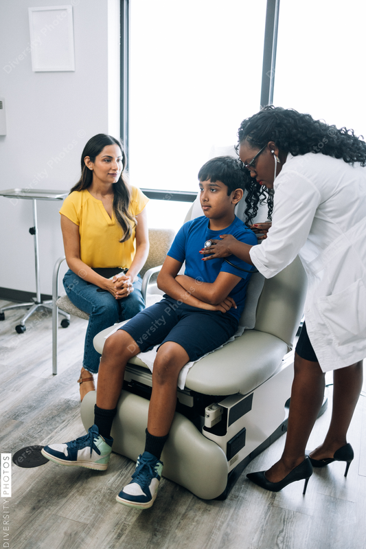 Black prediatric doctor consulting Indian patients