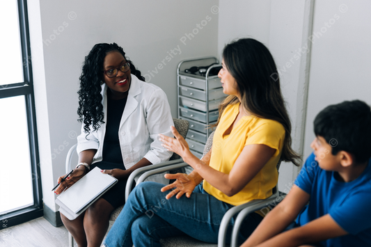 Black prediatric doctor consulting Indian patients