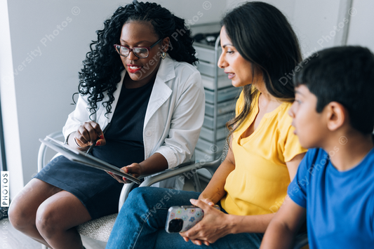 Black prediatric doctor consulting Indian patients