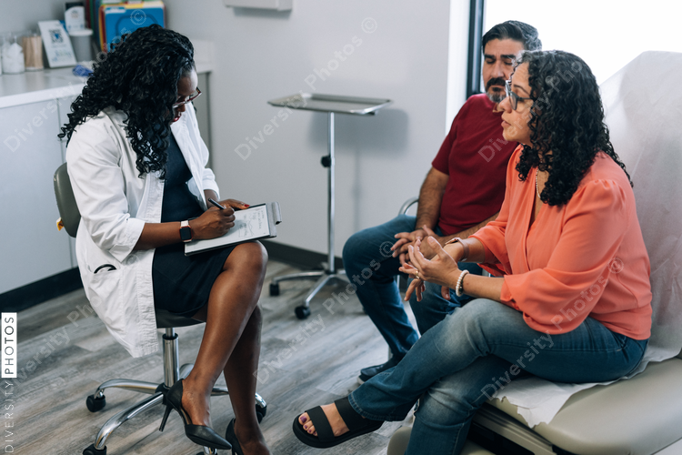Doctor consulting Hispanic patients