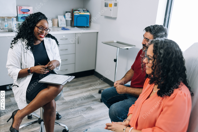 Black family medicine doctor consulting Hispanic patients