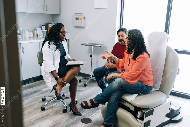 Black family medicine doctor consulting Hispanic patients