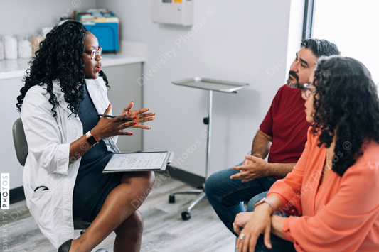 African American doctor consults Hispanic patients