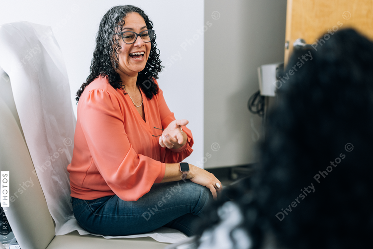 Hispanic female patient talking with doctor