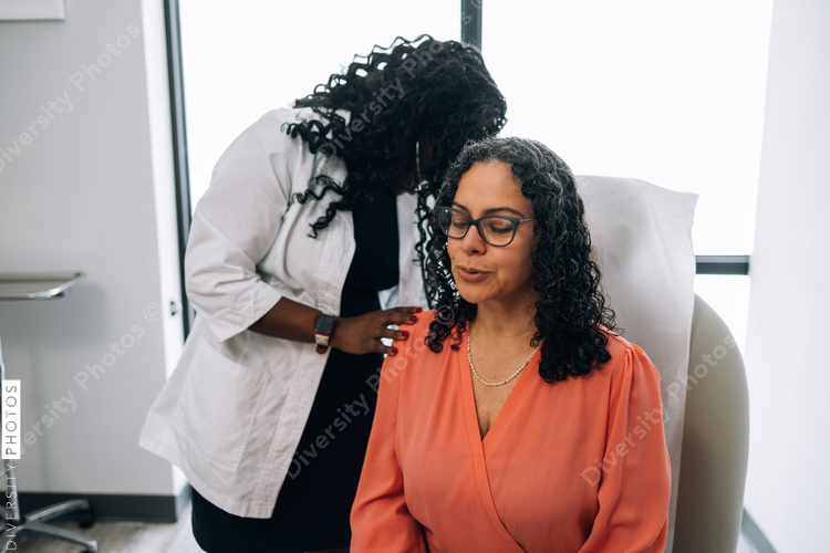 Black doctor consulting with female patient