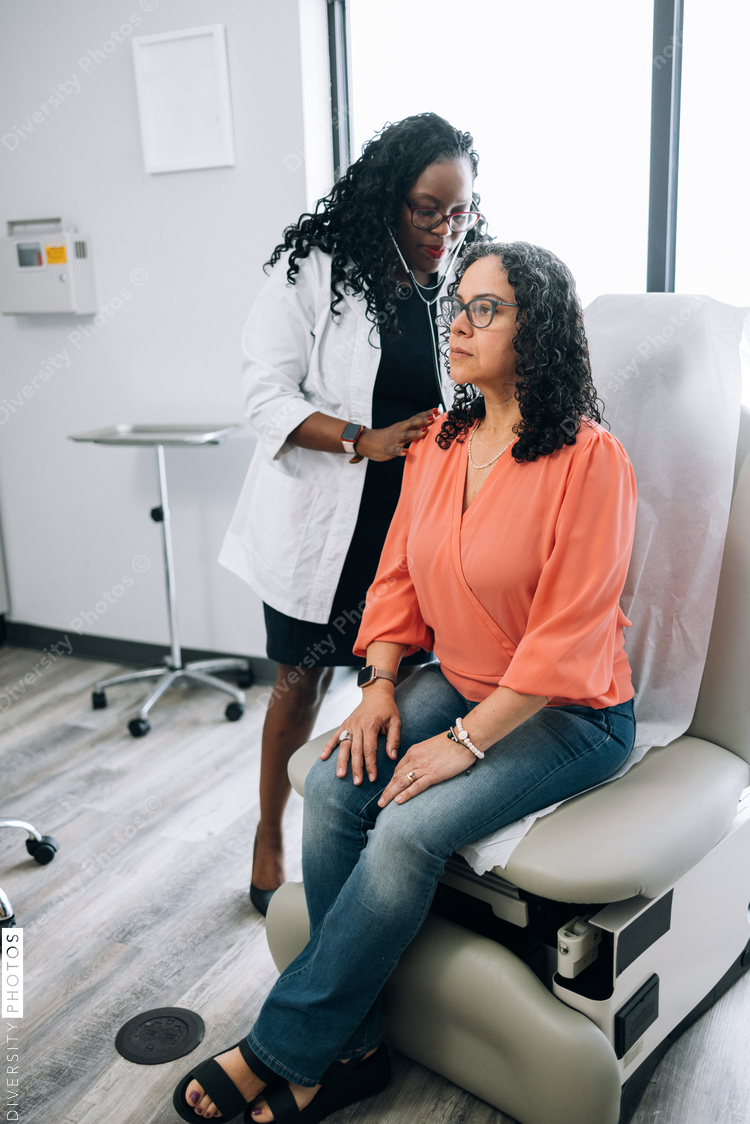 Black doctor consulting with female patient