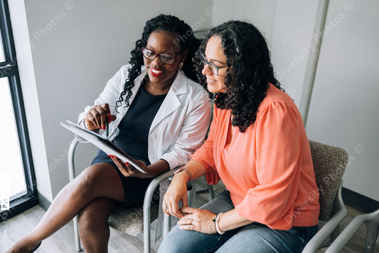 African American doctor consulting female Hispanic patient