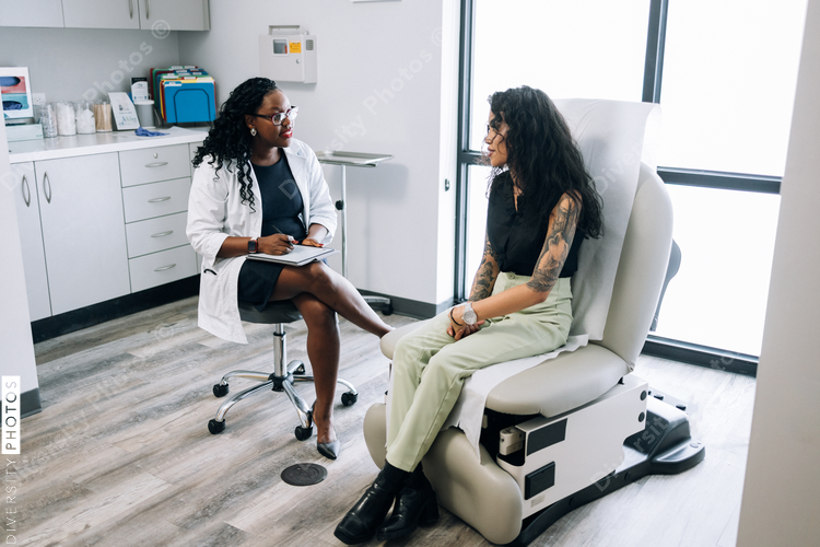 Doctor consulting gen Z mixed race patient