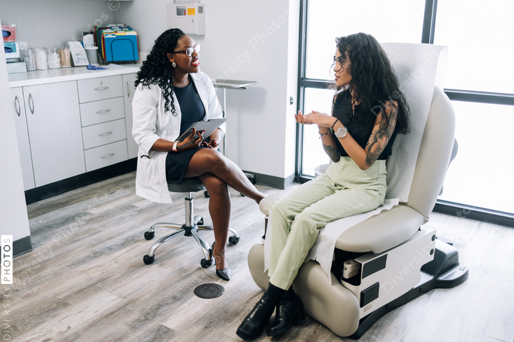 Doctor consulting gen Z mixed race patient