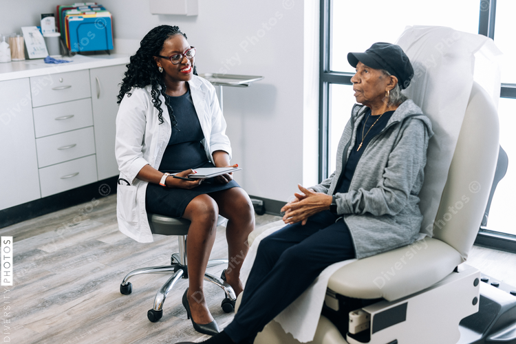 Black female doctor consulting senior patient