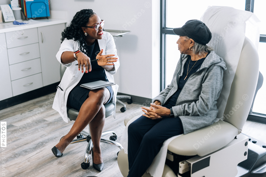 African American doctor consulting female senior patient