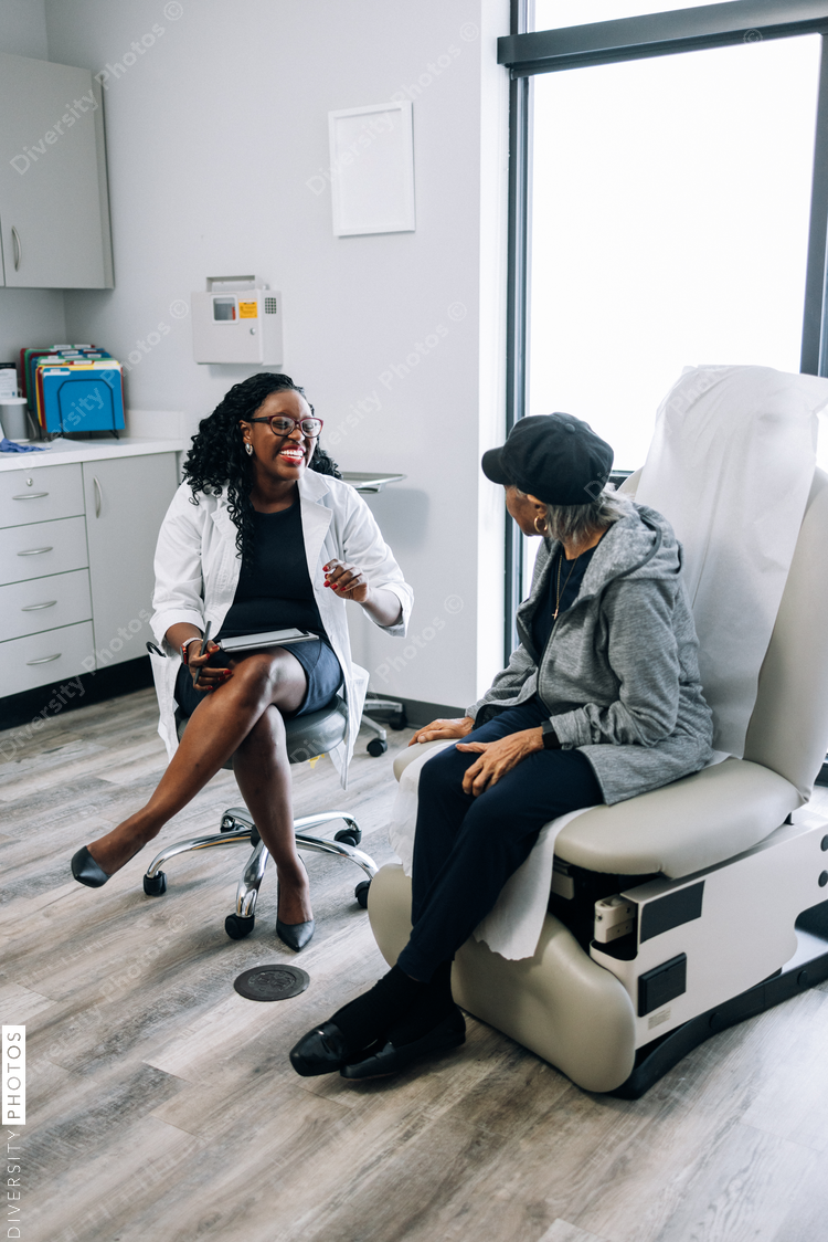 African American doctor consulting female senior patient