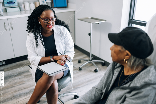 African American doctor consulting female senior patient