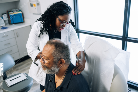 Black doctor consulting male patient