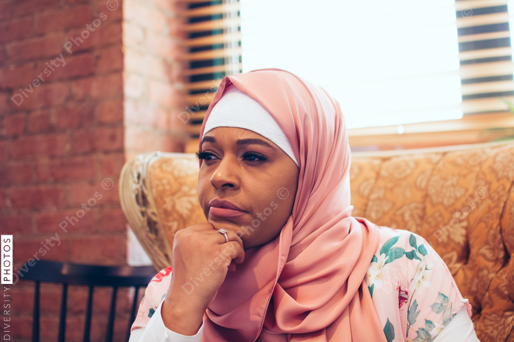 Close up of thoughtful woman sitting on chair 