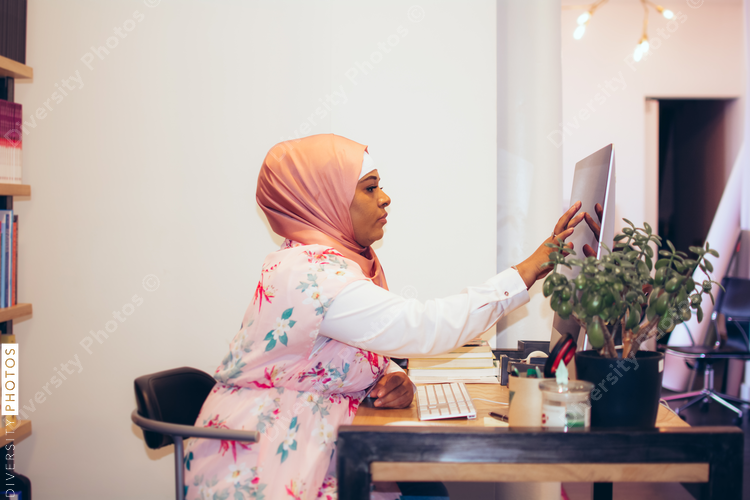 Side view of businesswoman using computer in office