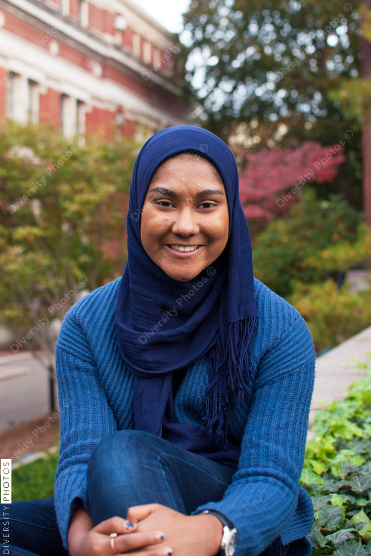 Portrait of smiling woman sitting at college campus