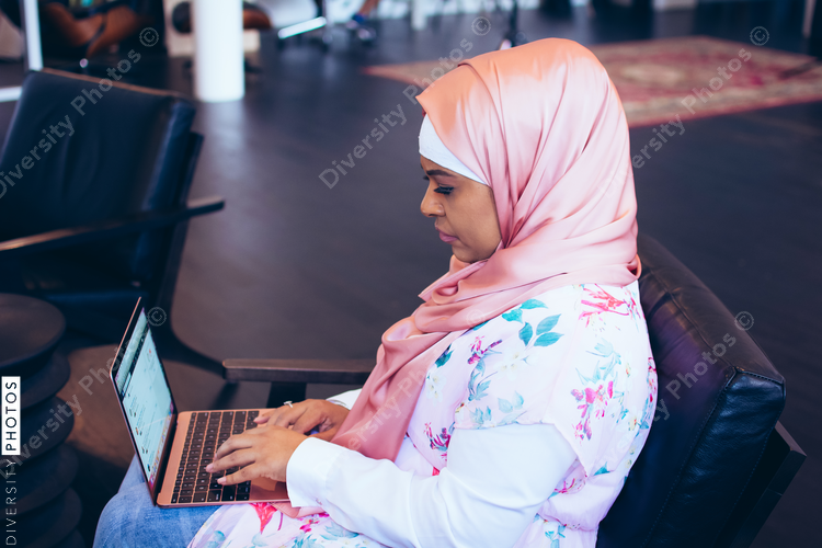 Side view of businesswoman working on laptop at office