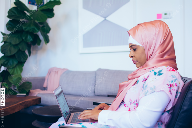 Side view of businesswoman working on laptop at office