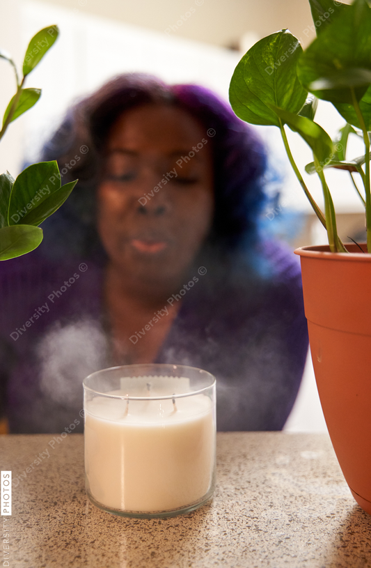 Black woman blowing out a candle